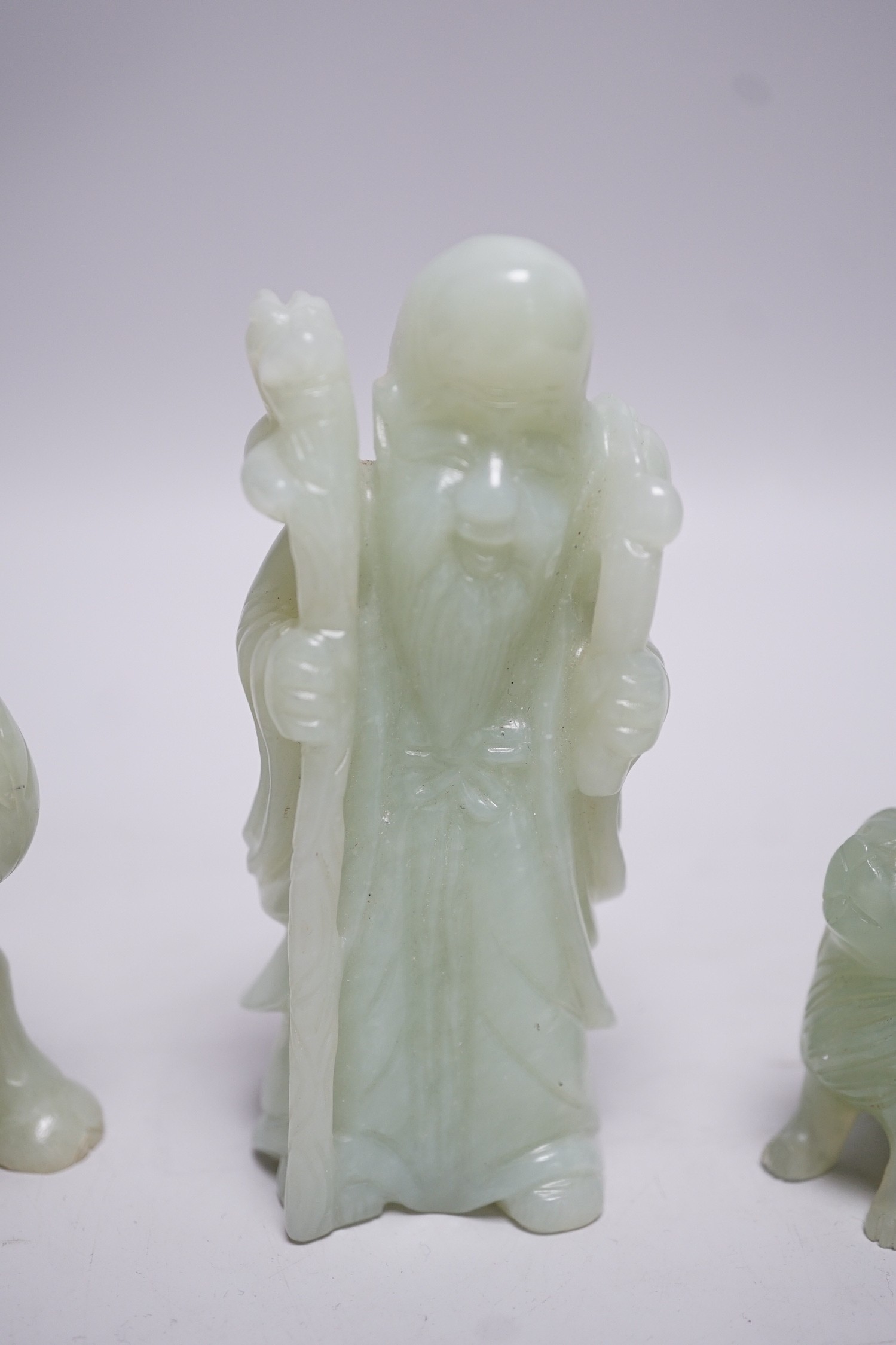 Three Chinese bowenite jade carvings of a Bactrian camel, a Pekinese dog and Shou Lao, tallest 12cm